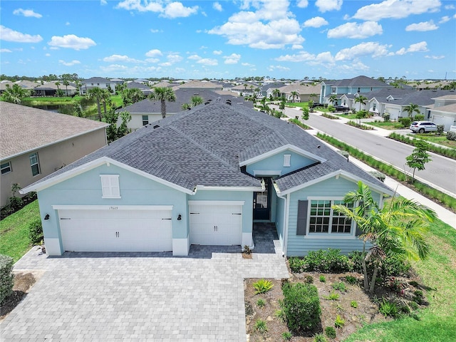 17629 Palmetto Pass Ln, Punta Gorda, FL 33982 - single story home with a residential view, a shingled roof, a garage, and decorative driveway
