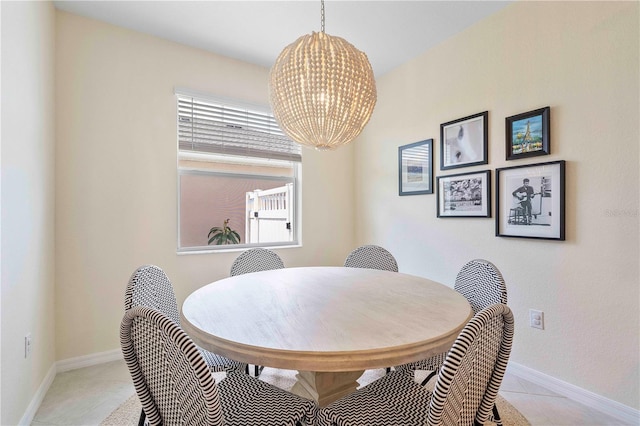 17629 Palmetto Pass Ln, Punta Gorda, FL 33982 - dining room featuring a chandelier, light tile patterned floors, and baseboards