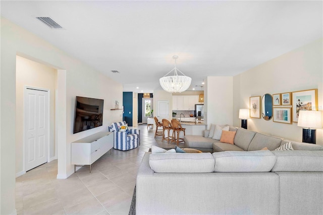 17629 Palmetto Pass Ln, Punta Gorda, FL 33982 - living area with a chandelier, light tile patterned flooring, baseboards, and recessed lighting