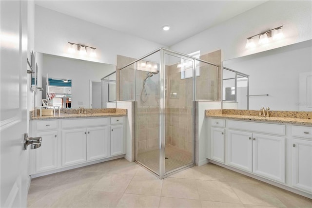 17629 Palmetto Pass Ln, Punta Gorda, FL 33982 - full bathroom featuring a shower stall, tile patterned floors, and two vanities