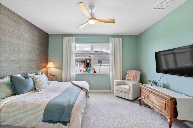 17629 Palmetto Pass Ln, Punta Gorda, FL 33982 - bedroom with an accent wall, carpet, ceiling fan, and baseboards