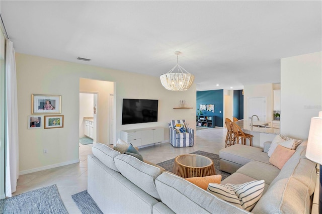 17629 Palmetto Pass Ln, Punta Gorda, FL 33982 - living area with a chandelier, light tile patterned flooring, and baseboards