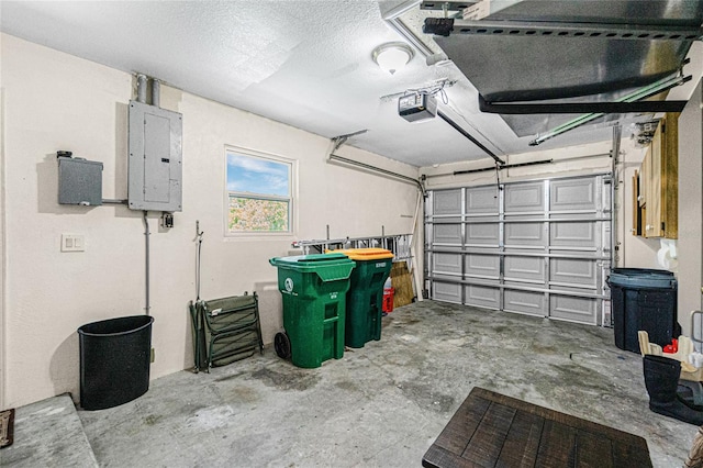 garage featuring electric panel and a garage door opener