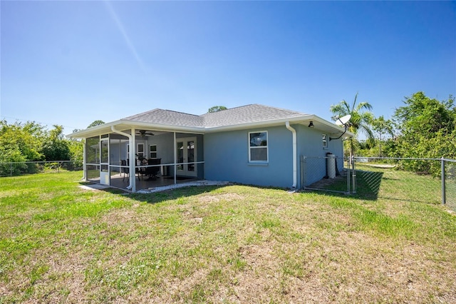 back of property featuring a sunroom, a ceiling fan, and stucco siding
