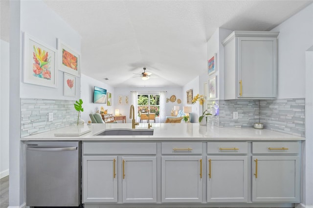 17396 Cox Ave, Port Charlotte, FL 33948 - kitchen with stainless steel dishwasher, a sink, a ceiling fan, gray cabinetry, and backsplash