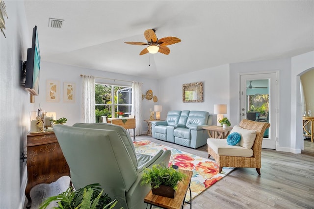 17396 Cox Ave, Port Charlotte, FL 33948 - living room featuring a ceiling fan, light wood-style floors, arched walkways, and baseboards