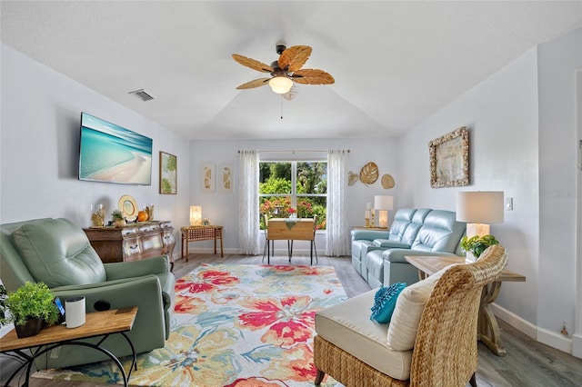 17396 Cox Ave, Port Charlotte, FL 33948 - living room featuring ceiling fan, wood finished floors, baseboards, and vaulted ceiling