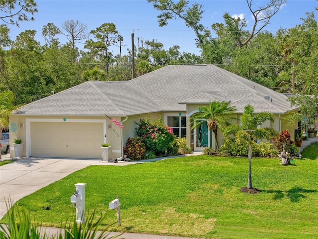 17396 Cox Ave, Port Charlotte, FL 33948 - single story home with an attached garage, stucco siding, concrete driveway, and a front lawn