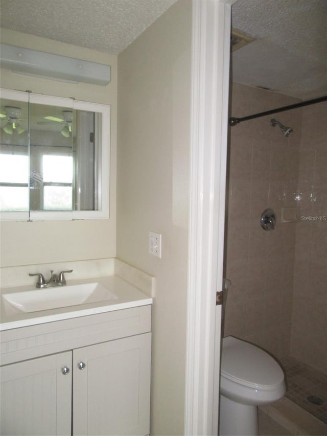26430 Rampart Blvd Unit 511, Punta Gorda, FL 33983 - bathroom with a textured ceiling, a shower stall, vanity, and toilet
