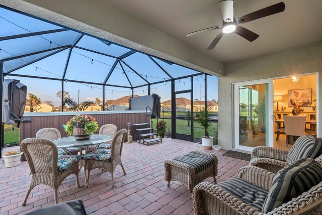 16032 Galiano Ct, Punta Gorda, FL 33955 - view of patio / terrace with a lanai, outdoor dining space, and a ceiling fan