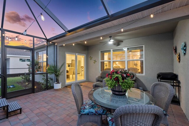16032 Galiano Ct, Punta Gorda, FL 33955 - patio terrace at dusk with a lanai and outdoor dining space