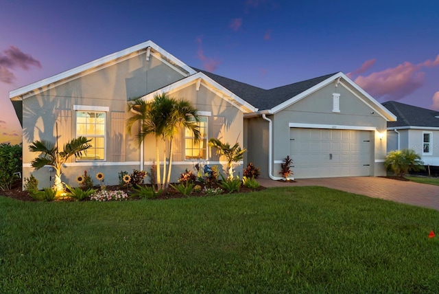 16032 Galiano Ct, Punta Gorda, FL 33955 - ranch-style home with a front yard, stucco siding, driveway, and an attached garage
