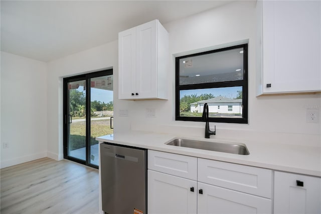 359 Salisbury St, Port Charlotte, FL 33954 - kitchen featuring dishwasher, a sink, light wood-type flooring, and white cabinets