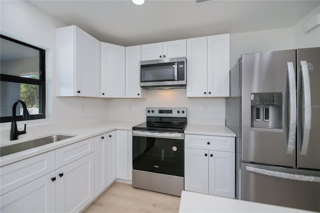 359 Salisbury St, Port Charlotte, FL 33954 - kitchen featuring stainless steel appliances, a sink, white cabinetry, and light countertops