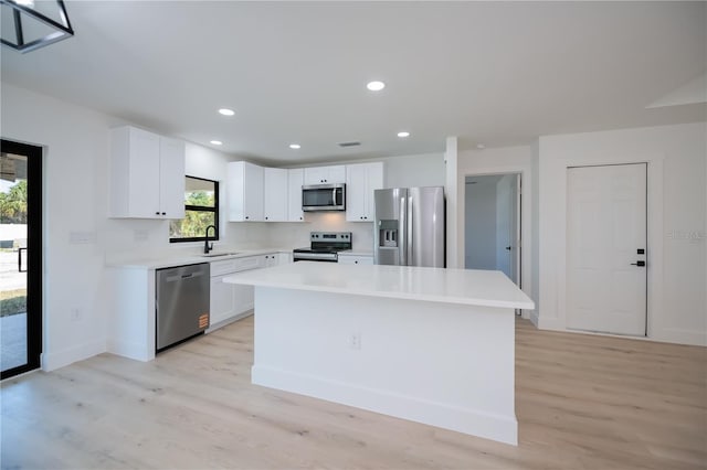 359 Salisbury St, Port Charlotte, FL 33954 - kitchen with appliances with stainless steel finishes, a sink, light wood-style floors, white cabinets, and recessed lighting