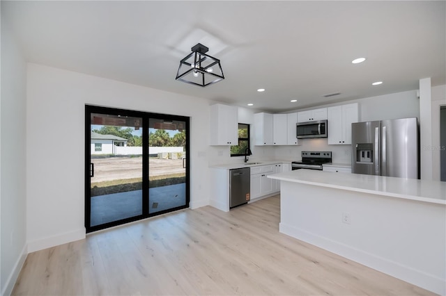359 Salisbury St, Port Charlotte, FL 33954 - kitchen featuring appliances with stainless steel finishes, light countertops, white cabinets, baseboards, and recessed lighting