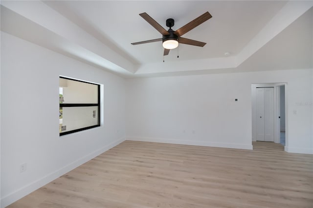359 Salisbury St, Port Charlotte, FL 33954 - spare room featuring a raised ceiling, light wood finished floors, ceiling fan, and baseboards