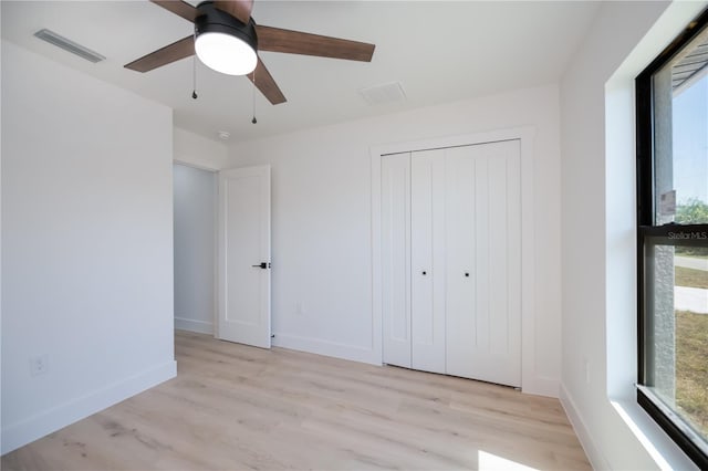 359 Salisbury St, Port Charlotte, FL 33954 - unfurnished bedroom with light wood-style flooring, a closet, and baseboards