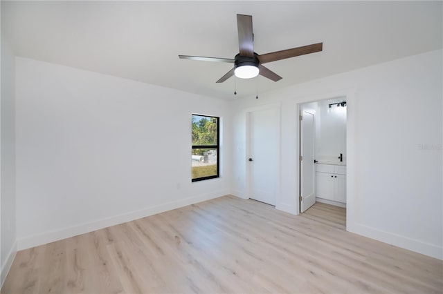 359 Salisbury St, Port Charlotte, FL 33954 - unfurnished bedroom featuring light wood-style floors, baseboards, ensuite bathroom, and a ceiling fan