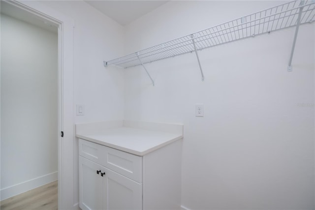 359 Salisbury St, Port Charlotte, FL 33954 - clothes washing area featuring baseboards and light wood finished floors