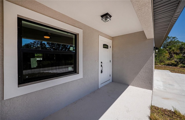 359 Salisbury St, Port Charlotte, FL 33954 - doorway to property featuring stucco siding