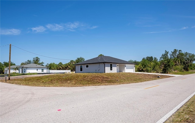359 Salisbury St, Port Charlotte, FL 33954 - view of front facade featuring driveway and a garage