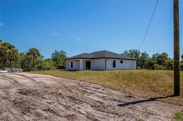 359 Salisbury St, Port Charlotte, FL 33954 - view of side of home featuring stucco siding and a yard