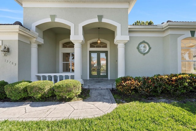 13783 Palmetto Point Ct, Port Charlotte, FL 33953 - doorway to property with french doors, stucco siding, and a porch