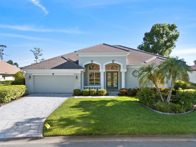 13783 Palmetto Point Ct, Port Charlotte, FL 33953 - mediterranean / spanish home featuring french doors, a garage, and stucco siding