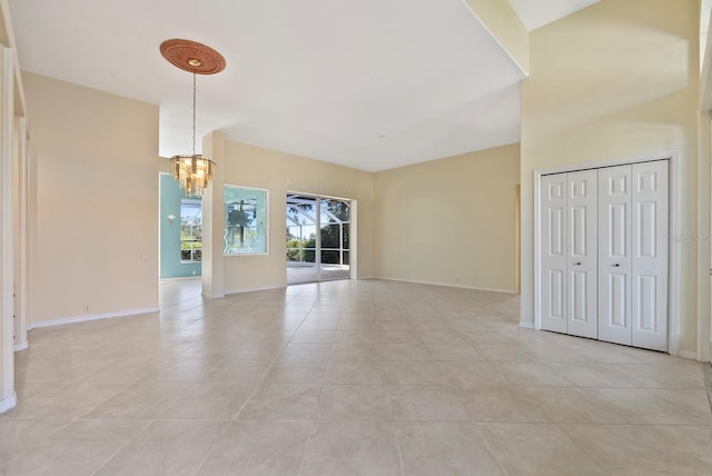 13783 Palmetto Point Ct, Port Charlotte, FL 33953 - unfurnished living room with a chandelier, light tile patterned floors, and baseboards