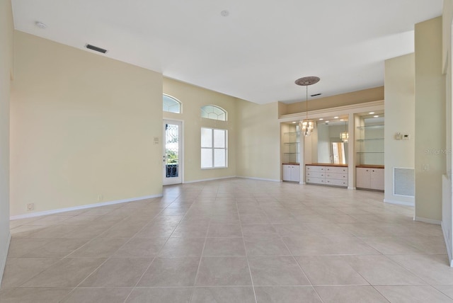 13783 Palmetto Point Ct, Port Charlotte, FL 33953 - spare room with light tile patterned floors, baseboards, and a chandelier
