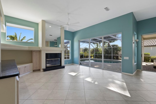13783 Palmetto Point Ct, Port Charlotte, FL 33953 - unfurnished living room featuring ceiling fan, a sunroom, plenty of natural light, and light tile patterned flooring