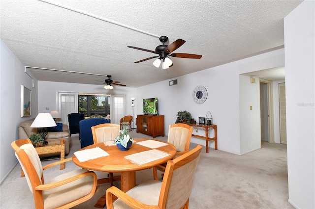 601 Islamorada Blvd Unit 24B, Punta Gorda, FL 33955 - dining room with light carpet, a ceiling fan, and a textured ceiling