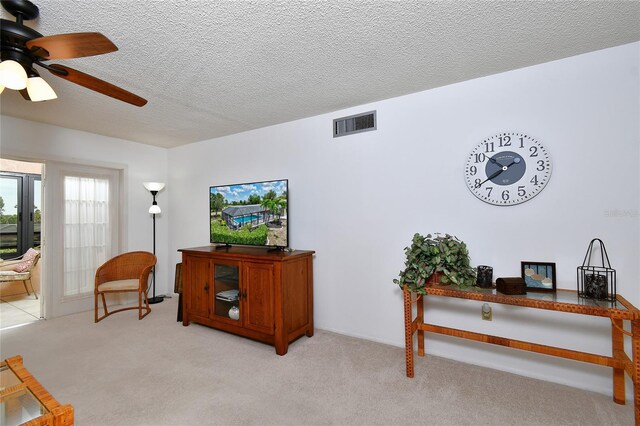 601 Islamorada Blvd Unit 24B, Punta Gorda, FL 33955 - living area with ceiling fan, light colored carpet, and a textured ceiling