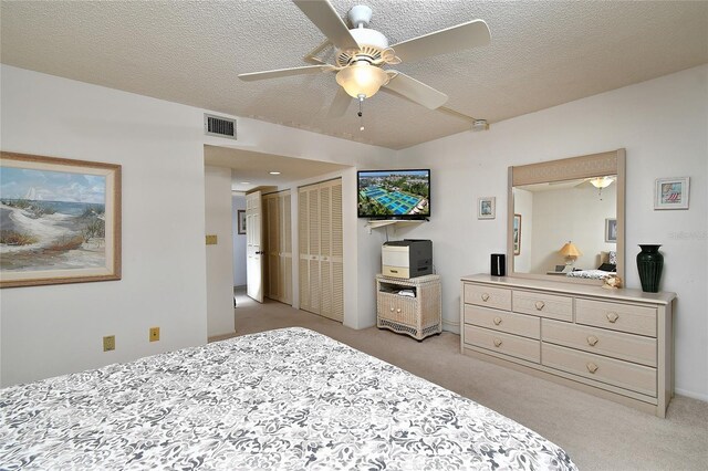 601 Islamorada Blvd Unit 24B, Punta Gorda, FL 33955 - bedroom featuring light colored carpet, a textured ceiling, and ceiling fan