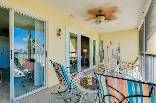 410 Cerromar Cir S Unit 240, Venice, FL 34293 - sunroom / solarium featuring wood finished floors, ceiling fan, and plenty of natural light