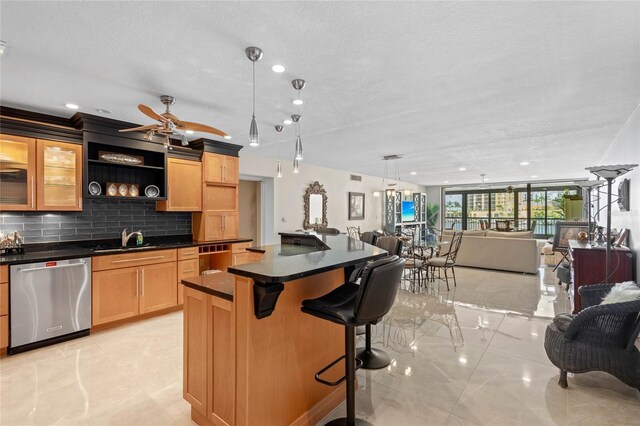 3250 Southshore Dr Unit 54B, Punta Gorda, FL 33955 - kitchen featuring dishwasher, open floor plan, a sink, backsplash, and dark countertops
