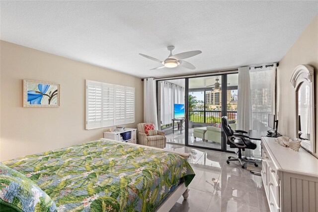 3250 Southshore Dr Unit 54B, Punta Gorda, FL 33955 - bedroom with access to exterior, a desk, light marble finish floors, ceiling fan, and a textured ceiling