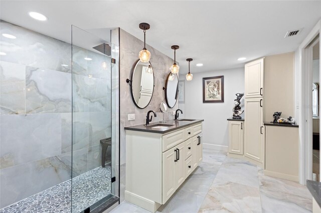 3250 Southshore Dr Unit 54B, Punta Gorda, FL 33955 - bathroom with double vanity, a tile shower, recessed lighting, and marble finish floors