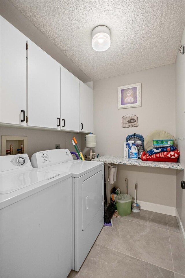3250 Southshore Dr Unit 54B, Punta Gorda, FL 33955 - laundry area featuring cabinet space, independent washer and dryer, a textured ceiling, and baseboards