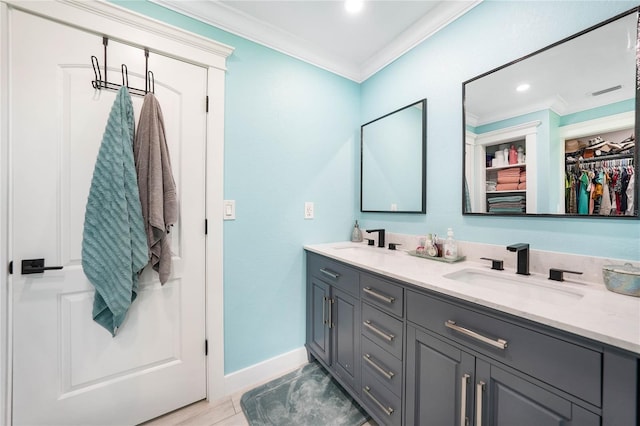 192 Danforth Dr S, Port Charlotte, FL 33980 - full bath featuring ornamental molding, baseboards, double vanity, a walk in closet, and recessed lighting