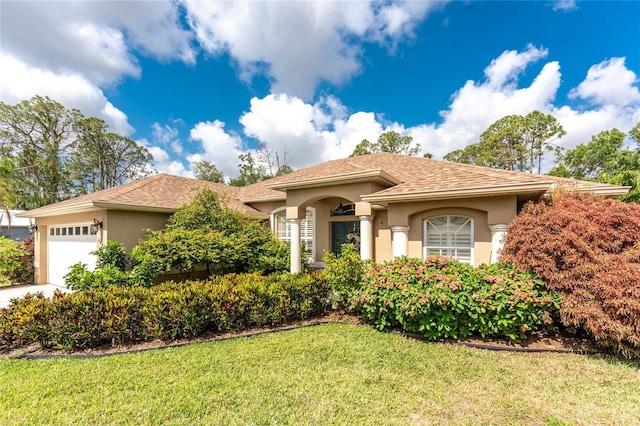 4443 Abcor Rd, North Port, FL 34286 - mediterranean / spanish home with stucco siding, a garage, a front yard, and a shingled roof