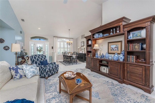 4443 Abcor Rd, North Port, FL 34286 - living area featuring a chandelier, light tile patterned flooring, and vaulted ceiling