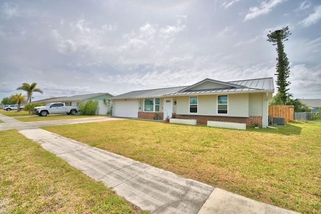 13495 Newport Ave, Port Charlotte, FL 33981 - single story home featuring a standing seam roof, concrete driveway, a garage, brick siding, and metal roof