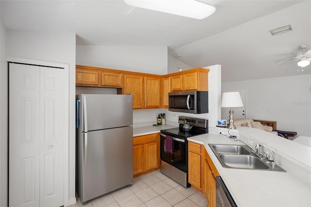 3886 Cincinnati St, North Port, FL 34286 - kitchen with appliances with stainless steel finishes, a sink, vaulted ceiling, light countertops, and light tile patterned floors