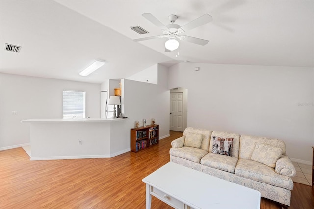 3886 Cincinnati St, North Port, FL 34286 - living area featuring vaulted ceiling, light wood-type flooring, ceiling fan, and baseboards