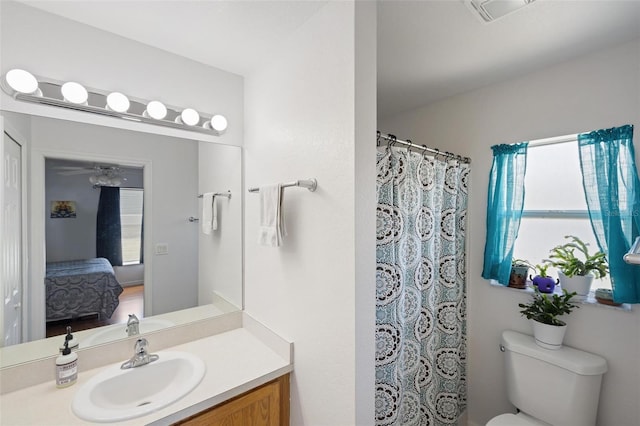 3886 Cincinnati St, North Port, FL 34286 - ensuite bathroom featuring vanity, healthy amount of natural light, toilet, and a shower with curtain