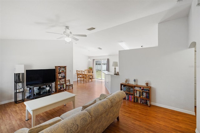 3886 Cincinnati St, North Port, FL 34286 - living room featuring a ceiling fan, lofted ceiling, wood finished floors, and baseboards