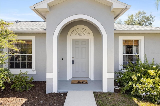 3886 Cincinnati St, North Port, FL 34286 - entrance to property featuring roof with shingles and stucco siding