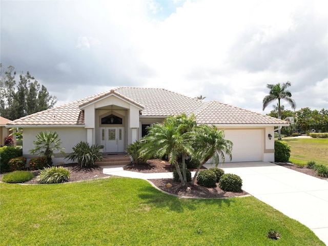 3518 Terin Ct, Punta Gorda, FL 33950 - mediterranean / spanish home with a front lawn, an attached garage, stucco siding, concrete driveway, and a tile roof